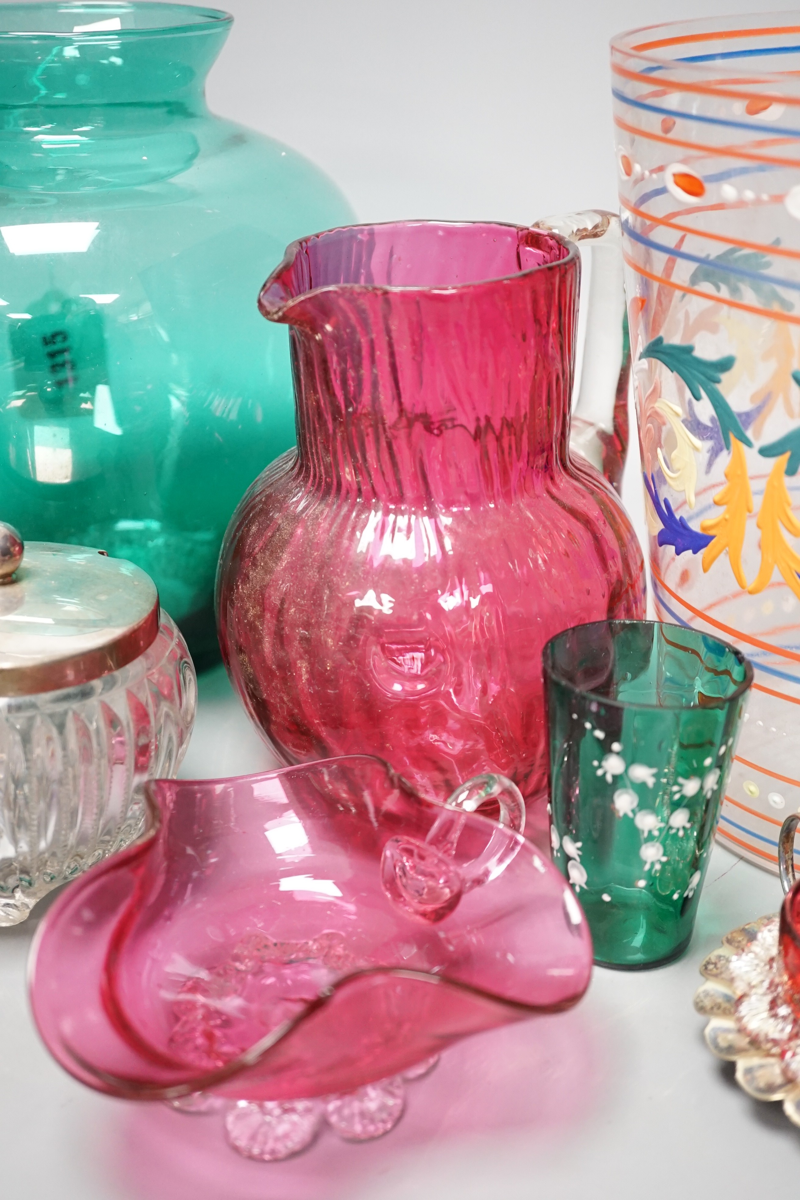 A collection of cranberry glass, a silver lidded glass sugar bowl, and enamelled glass historismus humpen etc